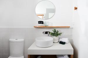 a white bathroom with a sink and a mirror at Reflections Evans Head - Holiday Park in Evans Head