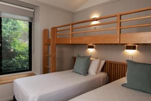 
a bedroom with two beds and a window at Reflections Holiday Parks Evans Head in Evans Head
