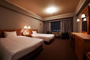 Rúm í herbergi á Hotel Agora Regency Osaka Sakai