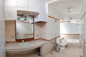 a bathroom with a sink and a toilet and a mirror at Moustache Delhi in New Delhi