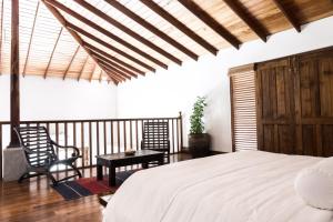 a bedroom with a bed and a table and a chair at Villa White Queen Resort & Spa in Galle +142 photos