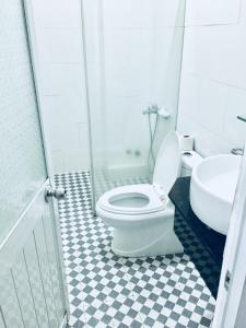 a bathroom with a toilet and a sink at Hotel Hồng Hạc nha trang in Nha Trang +35 photos