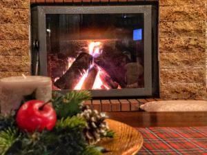 an apple on a table in front of a fireplace at Varosi Guesthouse in Edessa