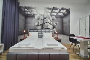 a bedroom with a large white bed and a desk at K51 Apartman | Budapest in Budapest