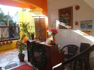 a room with a counter with flowers and plants at Lan Bless Pension House in Coron