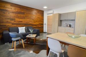 a living room with a couch and a table at Apartmány Málek in Valtice