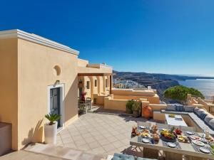 a house with a patio with a view of the ocean at Archipel Mansion in Fira