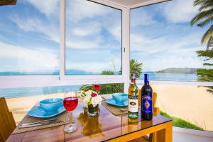 a table with two bottles of wine and two glasses at B1 Beachfront Apartments in Bophut 