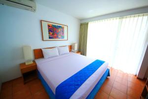 Ένα ή περισσότερα κρεβάτια σε δωμάτιο στο Concordia Hotel Bumi Sangkuriang Bandung