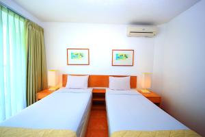 Ένα ή περισσότερα κρεβάτια σε δωμάτιο στο Concordia Hotel Bumi Sangkuriang Bandung