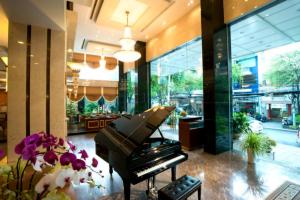 a piano in the lobby of a store at Northern Saigon Hotel in Ho Chi Minh City