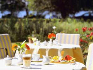 uma mesa branca com pratos de comida e bebidas em Hotel Seewisch em Flessenow