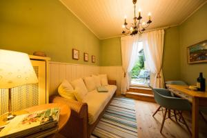 a living room with a couch and a table and a window at Landhaus Hindenburg in Bad Gleichenberg