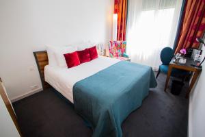 a bedroom with a large bed with red pillows at The Ambassador in Geneva