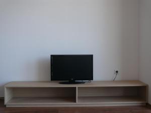 a television sitting on top of a wooden shelf at Complex Kentavar - Free Fast WiFi in Sveti Vlas