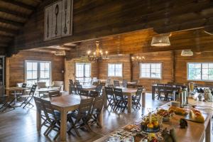 a dining room with wooden walls and tables and chairs at Domaine De La Boulaie in Treize-Vents