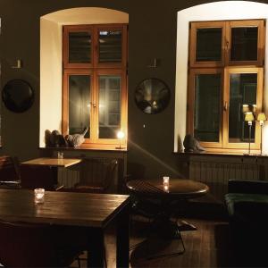 un restaurant avec deux tables et deux fenêtres dans l'établissement Duval Apartments, à Varsovie