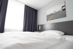 Postel nebo postele na pokoji v ubytování Airporthotel Grenchen