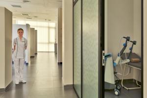 a man is standing in a hospital hallway at Borjomi Likani Health & Spa Centre in Borjomi
