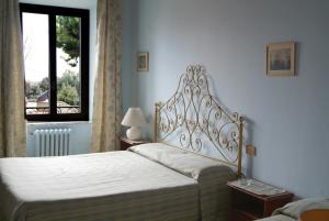 una camera da letto con due letti e una finestra di Albergo Lucia Pagnanelli a Castel Gandolfo