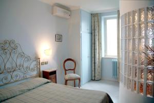 Postel nebo postele na pokoji v ubytování Albergo Lucia Pagnanelli