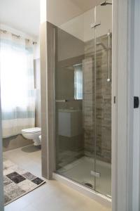 a glass shower in a bathroom with a toilet at La terrazza sul lago in Pergine Valsugana