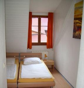 ein kleines Schlafzimmer mit einem Bett und einem Fenster in der Unterkunft Picobello Herberge in Görlitz