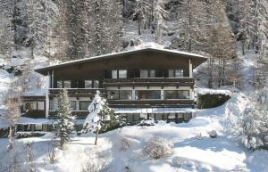 a house in the snow with snow covered trees at Pension Andreas in Sölden