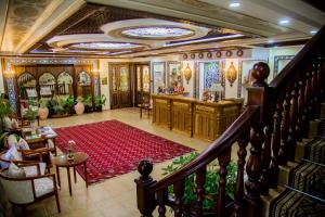 Hotel Grand Samarkand Superior - B في سمرقند: غرفة بها درج وسجادة حمراء في غرفة