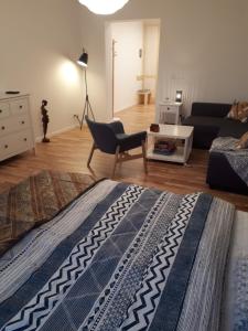 a living room with a bed and a couch at Apartament Pogodny in Jelenia Góra