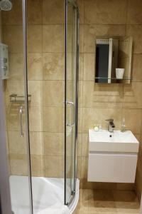 a bathroom with a shower and a sink at The Pityme Inn in Wadebridge