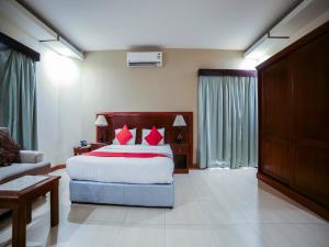 a bedroom with a large bed with red pillows at نايت ان للشقق المخدومة in Al Khobar +17 photos