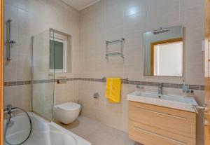 a bathroom with a sink toilet and a shower at Apartment with Pool in Sliema +36 photos