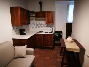 a kitchen with a couch and a table in a room at La Casina dell'Agania in Arezzo