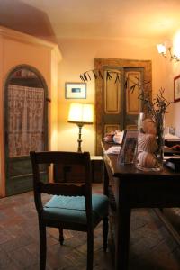 a dining room with a wooden table and a chair at Locanda di Porta Antica in San Benedetto del Tronto