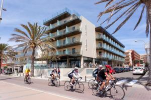 a group of people riding bikes down a street at Hotel Eden Palma Playa Adults Only in Can Pastilla