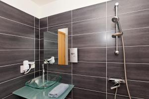 a bathroom with a glass sink and a mirror at Butterfly Boutique Hotel in Rhodes Town