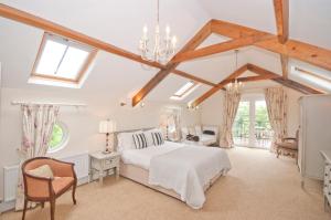 a bedroom with a white bed and a chair at Bellfry at Old Boley in Wexford