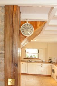 a kitchen with a clock on the wall at Bellfry at Old Boley in Wexford