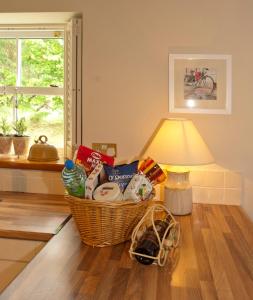 a basket of groceries sitting on the floor next to a lamp at Bellfry at Old Boley in Wexford