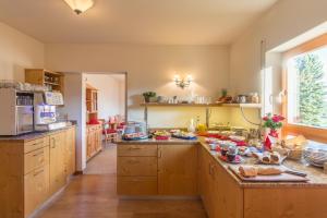 a kitchen with wooden cabinets and a counter top at Gästehaus Burgblick in Bisingen