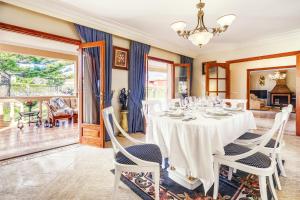 a dining room with a white table and chairs at VILLA CHABELA en Bah&iacute;a Grande Zona Residencial in Badia Blava