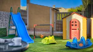 a backyard with a playground with a slide and a ball at VILLA CHABELA en Bah&iacute;a Grande Zona Residencial in Badia Blava