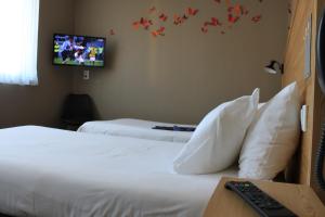 Postel nebo postele na pokoji v ubytování Mon Hotel à Gap