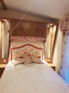 a bedroom with a large bed with two mirrors at Tarka holiday park, 5A in Barnstaple