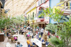 a group of people sitting at tables in a restaurant at Hotel Nordseeküste by Center Parcs in Tossenserdeich