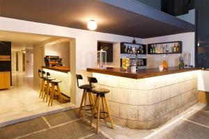 a bar in a restaurant with stools at Butterfly Boutique Hotel in Rhodes Town