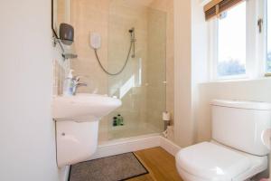 a bathroom with a toilet and a sink and a shower at Hillside House in Chester +22 photos
