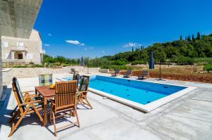 契利比的住宿－Villa Matanovi Dvori，游泳池旁带桌椅的天井