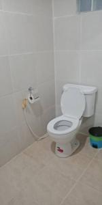 a bathroom with a white toilet in a room at hello meme house in Ko Lanta